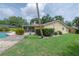 Exterior view of home's backyard with screened porch and tropical landscaping at 7902 Heather Ct, Tampa, FL 33634