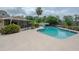 Backyard features swimming pool, patio and lush, mature landscaping at 7902 Heather Ct, Tampa, FL 33634