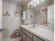 Bright bathroom with wainscoting, vanity, and large mirror at 7902 Heather Ct, Tampa, FL 33634