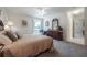 Comfortable bedroom with a view of the outdoors, carpeted floors, and ample natural light at 7902 Heather Ct, Tampa, FL 33634