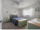 Charming bedroom featuring floral wallpaper, ample natural light, and coordinated furnishings at 7902 Heather Ct, Tampa, FL 33634