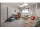 Cozy bedroom with light-filled window, ceiling fan, and floral couch at 7902 Heather Ct, Tampa, FL 33634