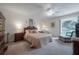 Cozy bedroom featuring a ceiling fan, neutral decor, and natural light from the window at 7902 Heather Ct, Tampa, FL 33634