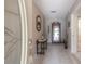 Inviting foyer with tile flooring, decorative mirror, and a glimpse of the living spaces at 7902 Heather Ct, Tampa, FL 33634