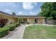 Charming covered entry with bench seating and attractive landscaping, creating a welcoming approach at 7902 Heather Ct, Tampa, FL 33634