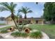 Charming single-story home with a well-manicured lawn, palm trees, and a two-car garage at 7902 Heather Ct, Tampa, FL 33634