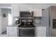 Bright kitchen with white cabinets, stainless steel appliances, and modern countertops at 7902 Heather Ct, Tampa, FL 33634