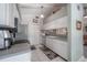 Bright kitchen with white cabinets, stainless steel appliances, and view into the living room at 7902 Heather Ct, Tampa, FL 33634