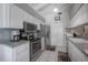 Bright kitchen with white cabinets, stainless steel appliances, and modern countertops at 7902 Heather Ct, Tampa, FL 33634