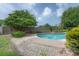 Beautiful pool with lush, mature landscaping and a fenced-in backyard at 7902 Heather Ct, Tampa, FL 33634