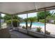 Screened-in patio boasts views of the sparkling pool with small palms and landscaped surroundings, perfect for relaxation at 7902 Heather Ct, Tampa, FL 33634