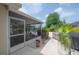 Screened in porch with chairs, table, and access to pool and backyard at 7902 Heather Ct, Tampa, FL 33634