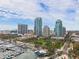 An aerial shot features a city skyline with modern buildings, a marina, and beautifully landscaped parks at 100 Beach Ne Dr # 301, St Petersburg, FL 33701