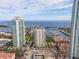 An aerial view captures luxury condos, a marina filled with boats, and a glimpse of the ocean for a premier waterfront living experience at 100 Beach Ne Dr # 301, St Petersburg, FL 33701