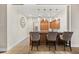 An elegant bar area is accentuated with pendant lighting, dark wood cabinets, and comfortable seating arrangements at 100 Beach Ne Dr # 301, St Petersburg, FL 33701
