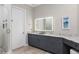 Bathroom with granite countertop, storage cabinets and modern square mirror at 100 Beach Ne Dr # 301, St Petersburg, FL 33701