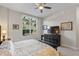 Bedroom featuring a window view of the backyard and dark wood furnishings at 100 Beach Ne Dr # 301, St Petersburg, FL 33701
