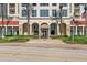 Elegant building exterior showcases a grand entrance with palm trees and manicured landscaping at 100 Beach Ne Dr # 301, St Petersburg, FL 33701