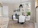 Bright dining area with a round table, white chairs, and a large window showcasing the exterior at 100 Beach Ne Dr # 301, St Petersburg, FL 33701