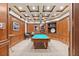 A sophisticated game room features wood paneling, coffered ceilings, and a full-sized pool table with pendant lighting at 100 Beach Ne Dr # 301, St Petersburg, FL 33701