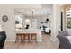 Open-concept kitchen with a breakfast bar, white cabinets, granite countertops, and stainless steel appliances at 100 Beach Ne Dr # 301, St Petersburg, FL 33701