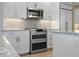 Stainless steel oven and microwave surrounded by white cabinets and granite countertops at 100 Beach Ne Dr # 301, St Petersburg, FL 33701
