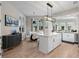 Open kitchen with granite island, stainless appliances, and seamless flow to dining area at 100 Beach Ne Dr # 301, St Petersburg, FL 33701