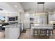 Modern kitchen with white cabinets, granite countertops, stainless steel appliances, and a stylish island with seating at 100 Beach Ne Dr # 301, St Petersburg, FL 33701
