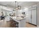 Bright and spacious kitchen features island with bar stools, stainless appliances, and modern lighting at 100 Beach Ne Dr # 301, St Petersburg, FL 33701