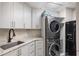 Well-organized laundry room features modern washer and dryer, sink, and ample storage space at 100 Beach Ne Dr # 301, St Petersburg, FL 33701