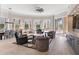 Open living area featuring stylish furniture, large windows, and views of the outdoor landscaping and dining area at 100 Beach Ne Dr # 301, St Petersburg, FL 33701