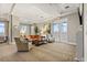 An inviting living room features large windows with decorative curtains and comfortable seating arrangements for relaxation at 100 Beach Ne Dr # 301, St Petersburg, FL 33701