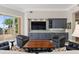 Living room features an entertainment center and access to a patio with outdoor seating at 100 Beach Ne Dr # 301, St Petersburg, FL 33701
