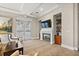 Relaxing living room with a fireplace, TV, comfortable chairs, and plenty of light from the glass doors at 100 Beach Ne Dr # 301, St Petersburg, FL 33701