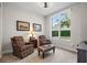 Bright sitting room with comfortable chairs, large window and neutral carpet at 100 Beach Ne Dr # 301, St Petersburg, FL 33701