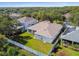 Aerial view of backyard with manicured lawn and white fence surrounded by lush trees at 10244 Shadow Branch Dr, Tampa, FL 33647