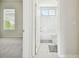 Bathroom view from doorway showing tub and tile with natural light from window in adjacent room at 10244 Shadow Branch Dr, Tampa, FL 33647