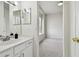 Bright bathroom featuring a white vanity with double sinks, modern lighting, and a neutral color palette at 10244 Shadow Branch Dr, Tampa, FL 33647