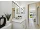 Bathroom with modern sink vanity and view into the living area at 10244 Shadow Branch Dr, Tampa, FL 33647