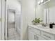 Bright bathroom featuring white vanity, stylish mirror, modern lighting, and open doorway to bath and toilet at 10244 Shadow Branch Dr, Tampa, FL 33647