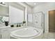 Light-filled bathroom with soaking tub, glass shower, and decorative accents at 10244 Shadow Branch Dr, Tampa, FL 33647