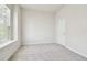 Cozy bedroom with neutral carpeting, a window with blinds for privacy, and a clean, minimalist aesthetic at 10244 Shadow Branch Dr, Tampa, FL 33647
