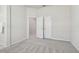 Cozy bedroom features plush carpeting, neutral paint, and double doors leading to a closet at 10244 Shadow Branch Dr, Tampa, FL 33647
