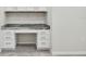 Close up on built-in desk in carpeted flex space with ample storage at 10244 Shadow Branch Dr, Tampa, FL 33647