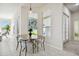 Bright breakfast nook with tile flooring, modern lighting, and a round wood table at 10244 Shadow Branch Dr, Tampa, FL 33647