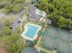 Aerial view of the community pool, lap pool, tennis courts and clubhouse, perfect for recreation and relaxation at 10244 Shadow Branch Dr, Tampa, FL 33647