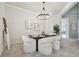 Dining area with elegant chandelier, a wooden table, and comfortable upholstered chairs at 10244 Shadow Branch Dr, Tampa, FL 33647