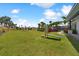 Outdoor exercise area on a lush green lawn, complimented by palm trees and clear blue skies at 10244 Shadow Branch Dr, Tampa, FL 33647