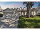 Charming single-story home features a three-car garage and well-manicured lawn at 10244 Shadow Branch Dr, Tampa, FL 33647