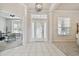 Bright foyer with white tile floors, transom window above the front door, and views to an office at 10244 Shadow Branch Dr, Tampa, FL 33647